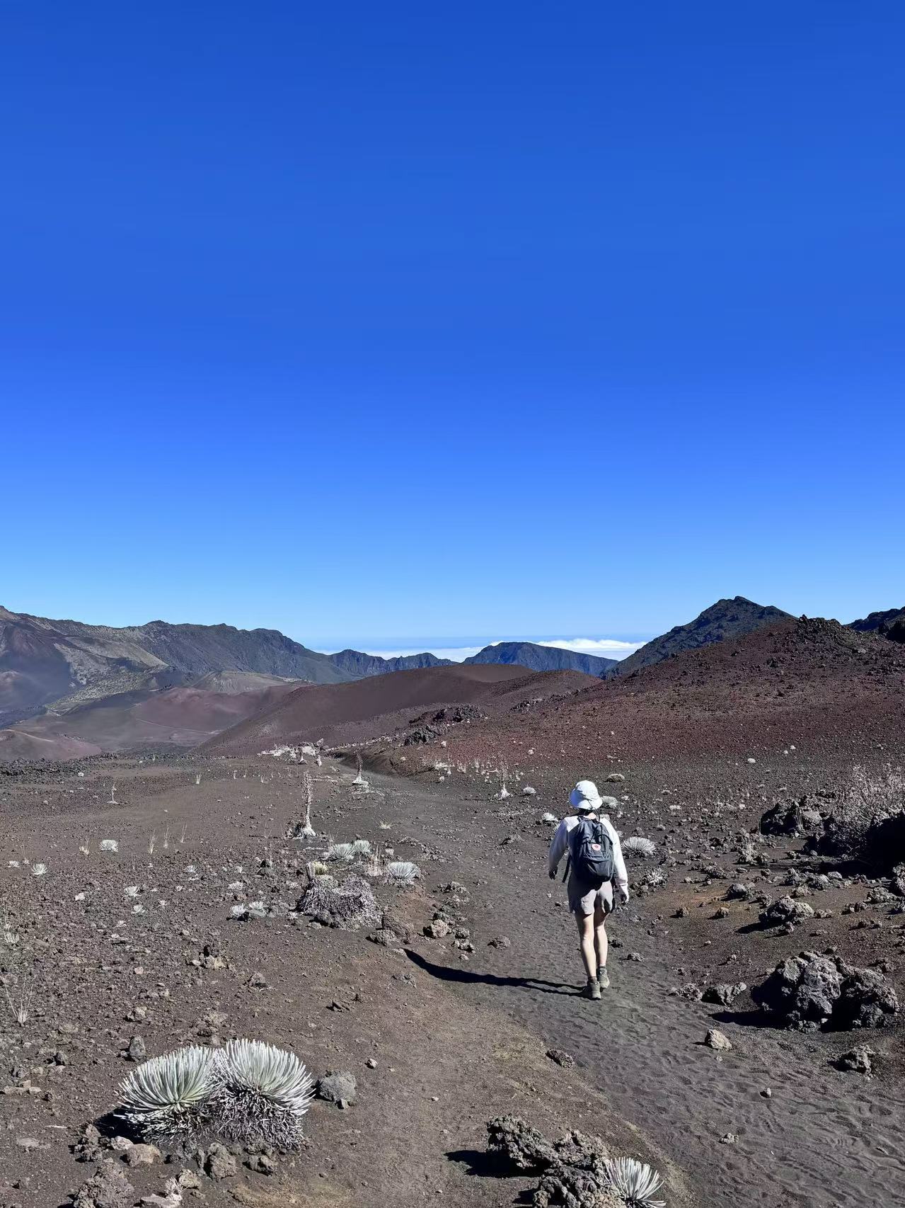Shirley walking alone across the volcanic landscape of Haleakalā